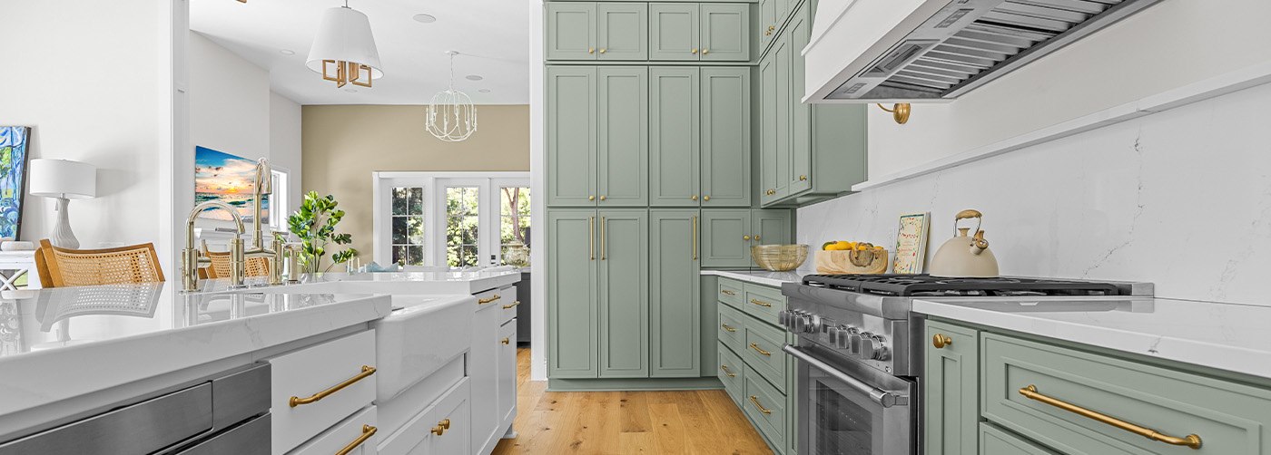 Modern kitchen with green cabinets and stainless steel appliances