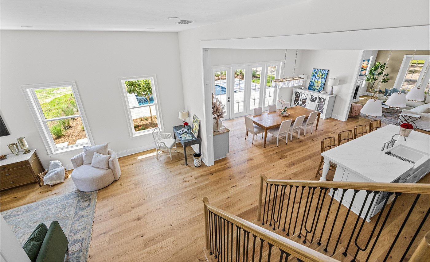 Bright living room and dining area with wooden floors and large windows