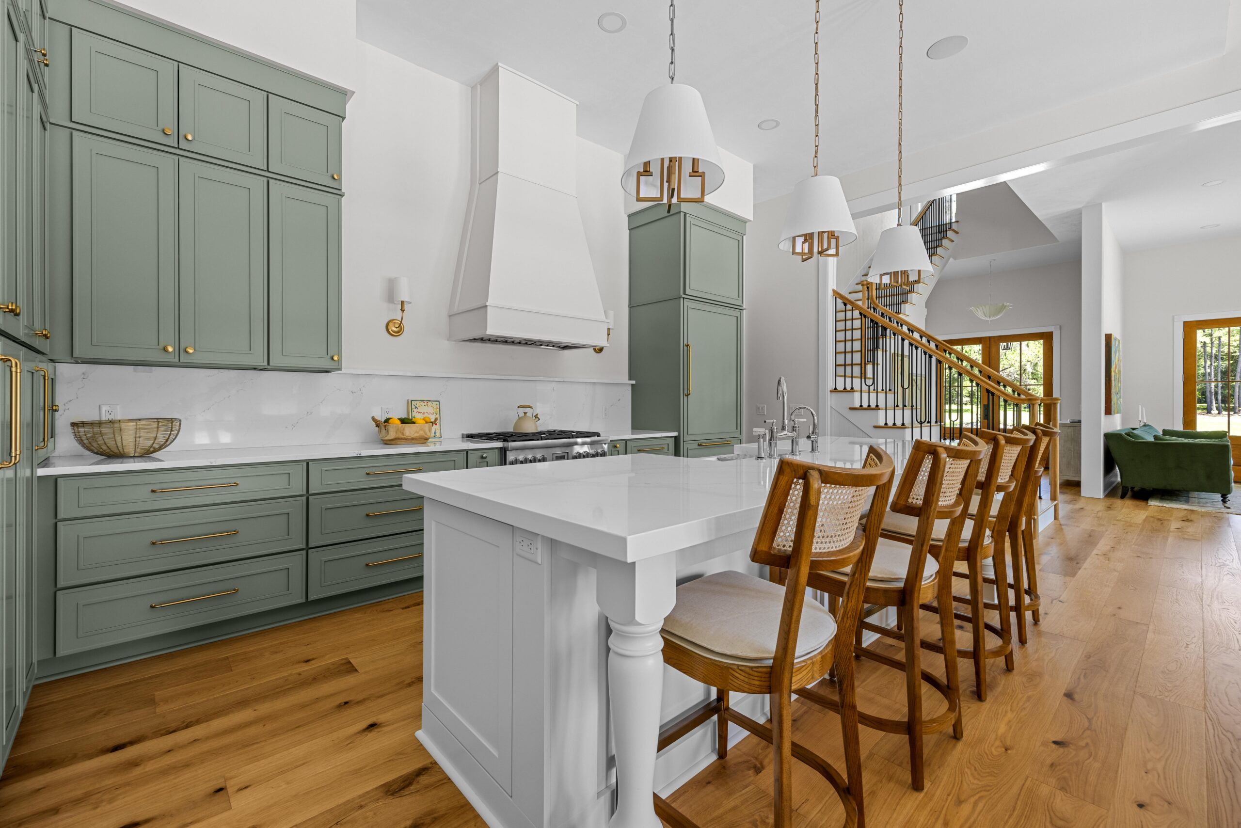 Interior view of a bright kitchen with an island and bar stools