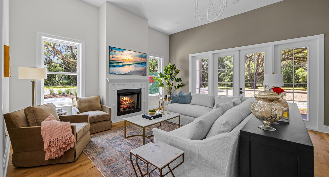 A modern remodeled contemporary living room with french doors and a white wood trim fireplace